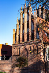 A beautiful red brick Gothic building. Ancient architecture.