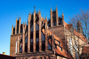 A beautiful red brick Gothic building. Ancient architecture.