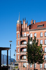A beautiful red brick Gothic building. Ancient architecture. Living space.