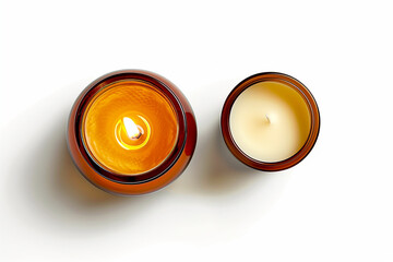 two isolated candles: burning soy way candle in an amber glass jar and a cream colored tea light, decorative lifestyle design elements over transparent background, top view / flat lay


