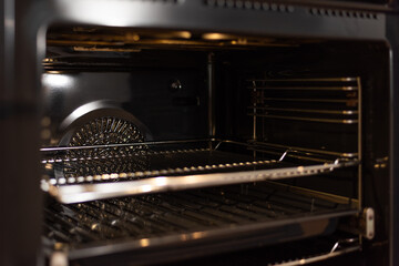 Empty open electric oven with hot air ventilation.