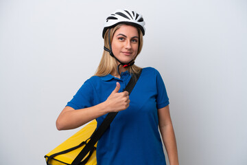 Young caucasian woman with thermal backpack isolated on white background giving a thumbs up gesture
