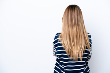 Young Uruguayan woman isolated on white background in back position