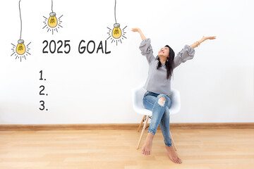 2025 goals with young woman raise arm  goals cheerful and happy new year with laptop on the sofa in living room.  Star together new year 2025