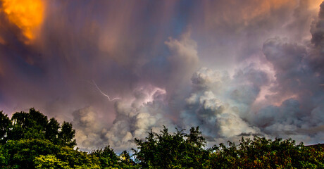 Lightning storm clouds at sunset.
