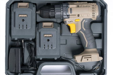 Complete set of electric screwdriver in suitcase on white background closeup.