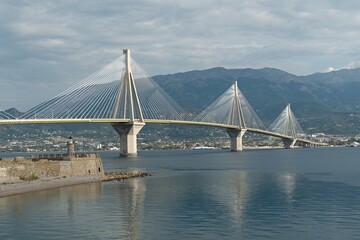 Obraz premium View of the bridge over the Gulf of Corinth Charilaos Trikoupis. It connects Rio city on the Peloponnesus with Antirrio city on mainland Greece. It is 2,880 meters long. Europe.