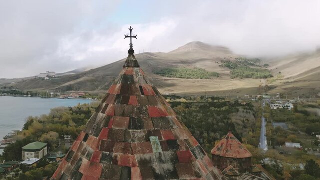 Aerial view cross and cupola over Sevanavank monastic complex. Peninsula at the northwestern shore of Lake Sevan in the Gegharkunik Province of Armenia. Popular travel sightseeing attraction