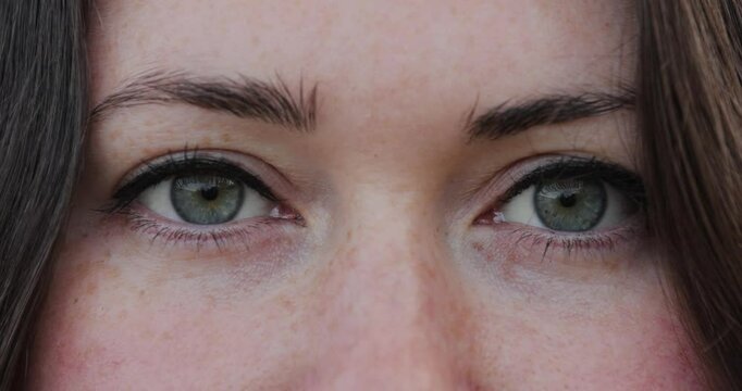 Closeup opening a woman eyes, slow motion