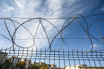Sharp razor wire fence, close up. Barbed tape. Concept of prison, immigration, detention, boundary...