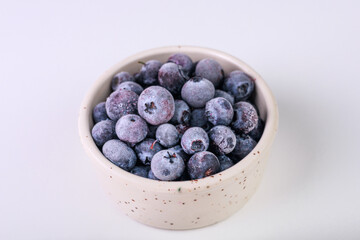 blueberries in a white bowl on a white background isolate
