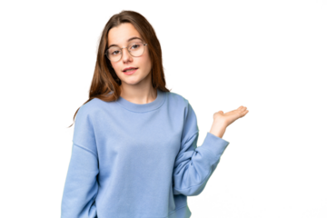 Teenager girl over isolated chroma key background holding copyspace imaginary on the palm to insert an ad