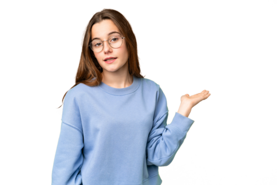 Teenager girl over isolated chroma key background holding copyspace imaginary on the palm to insert an ad