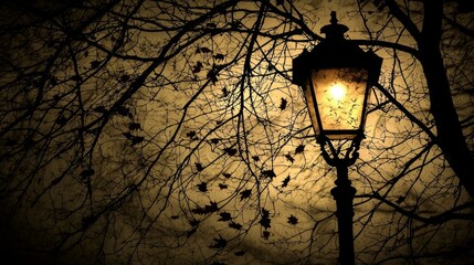 Eerie Autumn Night. Vintage Street Lamp with Falling Leaves Silhouetted Against a Moonlit Sky