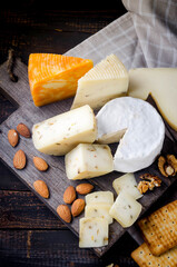Assorted cheese pieces, vegetables, honey, fruits, cookies and nuts