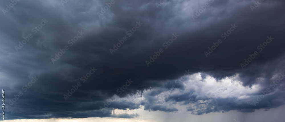 Poster the dark sky with heavy clouds converging and a violent storm before the rain.bad or moody weather s