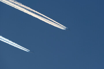 Airplane trails in the blue sky, contrails.