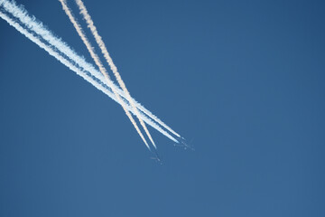 Airplane trails in the blue sky, contrails.