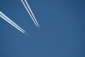 Airplane trails in the blue sky, contrails.