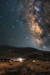 The night sky with the milky way shining brightly over a small town, great for use in astronomy or travel scenes