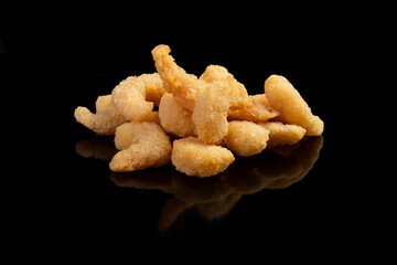 Delicious fried shrimp on a black background. Selective focus.