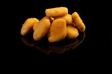 Delicious chicken nuggets on a black background.