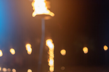 Blurred image of hot fire flame on torch at outdoor fire show