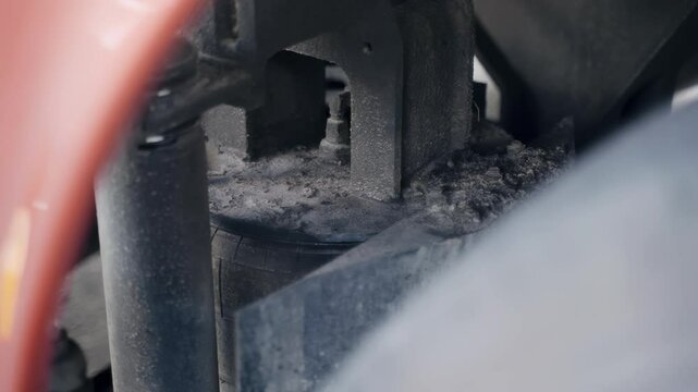 Discover the mechanics of a bus's air cushion shock absorption system as the camera glides smoothly from right to left, revealing intricate details and functioning parts in action.