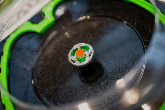 spinning beyblade toys in black plastic arena for young children