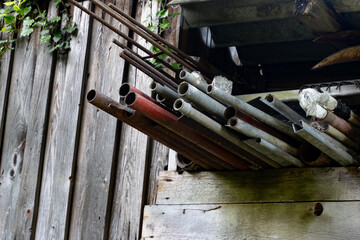 Old metal pipes and rods hanging out of a barn