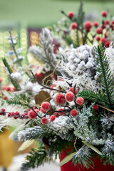 Christmas bouquet of pine needles with cones on green background with bokeh