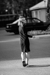 Portrait of a beautiful young girl in an urban environment. Black and white photo.