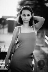 Portrait of a beautiful young girl in an urban environment. Black and white photo.