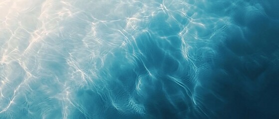 Fototapeta premium Beautiful clear water texture with soft ripples and sunlight reflections, creating a tranquil and serene aquatic scene.