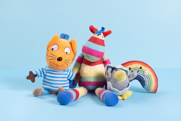 Different soft toys on a blue background, the concept of friendship and togetherness