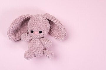 Handmade soft toy on a pink background