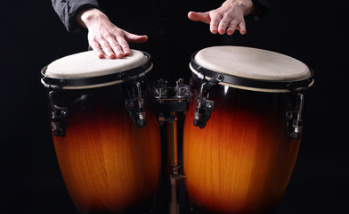 Obraz premium Drummer playing drums, different percussive musical instruments on a black background
