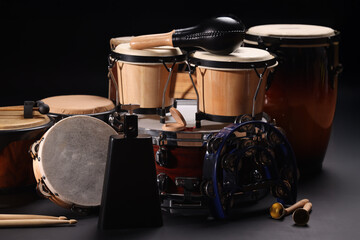 Different drums on a black background, percussion musical instruments