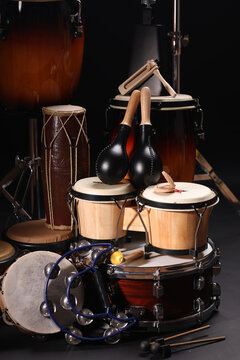 Different drums on a black background, percussion musical instruments