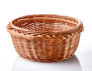 Obraz premium A close-up of an empty handcrafted woven basket set against a white background, highlighting its natural texture and traditional design. Ideal for storage, decoration, or gift presentation