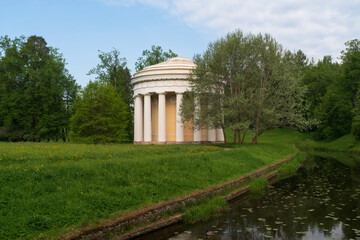 View of the Temple of Friendship on the bank of the Slavyanka River in the Pavlovsky Park on a sunny summer day, Pavlovsk, Saint Petersburg, Russia