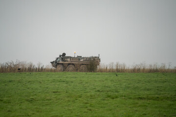 Fototapeta premium British army Patria Pasi Fuchs (Falcon Squadron) CBRN six-wheeled armoured personnel carrier vehicle on a military battle exercise, Wiltshire UK