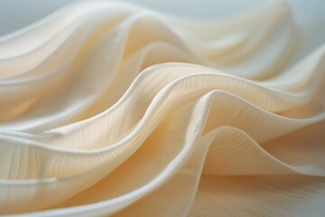 Obraz premium Gentle waves of creamy fabric create a mesmerizing play of light and texture, offering a tranquil and elegant study in minimalist beauty.