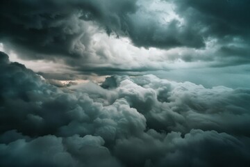 Obraz premium Dense clouds roil and churn, creating a dramatic and dynamic skyscape high above, capturing the untamed essence of nature.