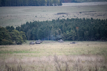 a group of a British army Warrior FV510 light infantry fighting vehicle tanks in action on a military exercise, Wiltshire UK