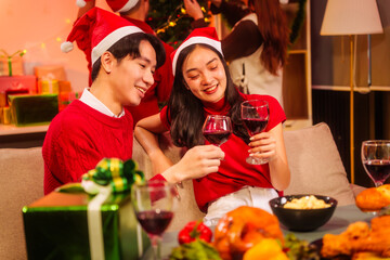 An upbeat New Year’s Eve celebration with Asian friends, family, colleagues, blending work and holiday vibes.while table brims with champagne, wine, gift boxes, delicious foods grilled chicken