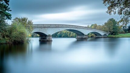 Fototapeta premium Elegant bridge spanning over a calm river background