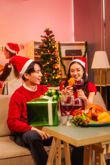 An upbeat New Year’s Eve celebration with Asian friends, family, colleagues, blending work and holiday vibes.while table brims with champagne, wine, gift boxes, delicious foods grilled chicken