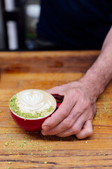 Barista hand serving coffee in a coffee shop