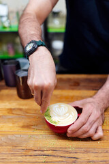 Barista making coffee in a coffee shop